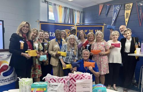 Meriwether co Rotary Club with Dist Gov Andre Marria putting together Its a Girls thing Bags.jpg